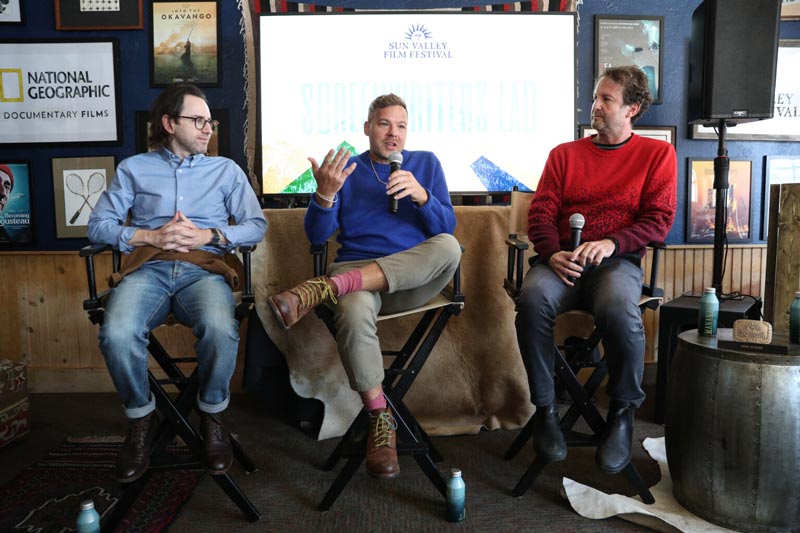 three men sitting down speaking into microphones