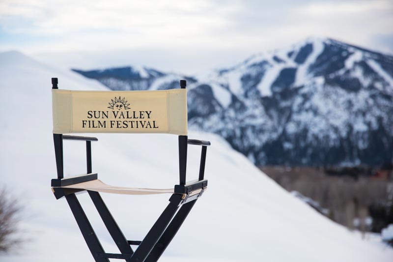 A sun valley film festival directors chair with bald mountain in the back