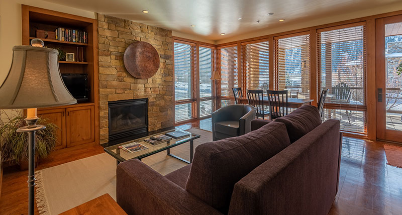 A living room with a couch, coffee table and a television in sun valley